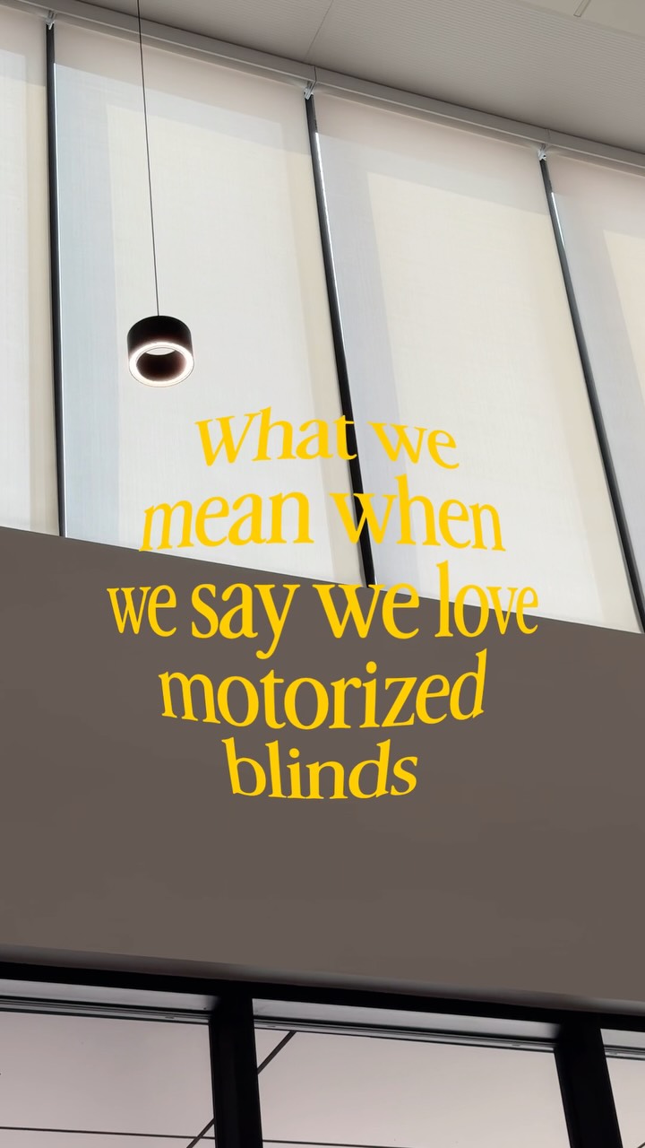 Light roller shades on tall windows in a Novo motorization reel.