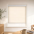 Custom light-filtering roller blind in Linen Beige with a white cassette, shown in a bright breakfast corner