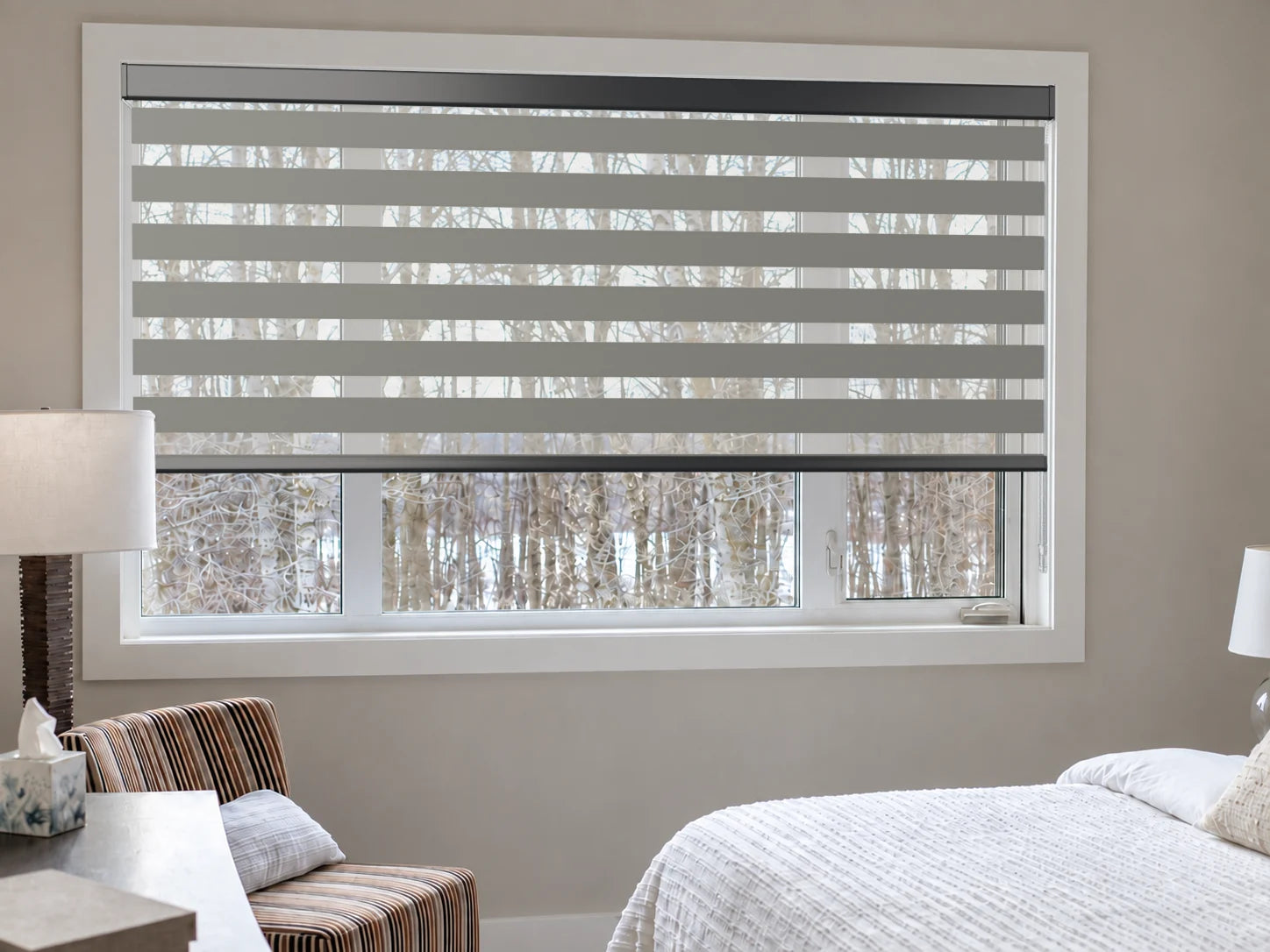 Illustrative bedroom view of a custom zebra blind in Twist Charcoal with a black cassette.